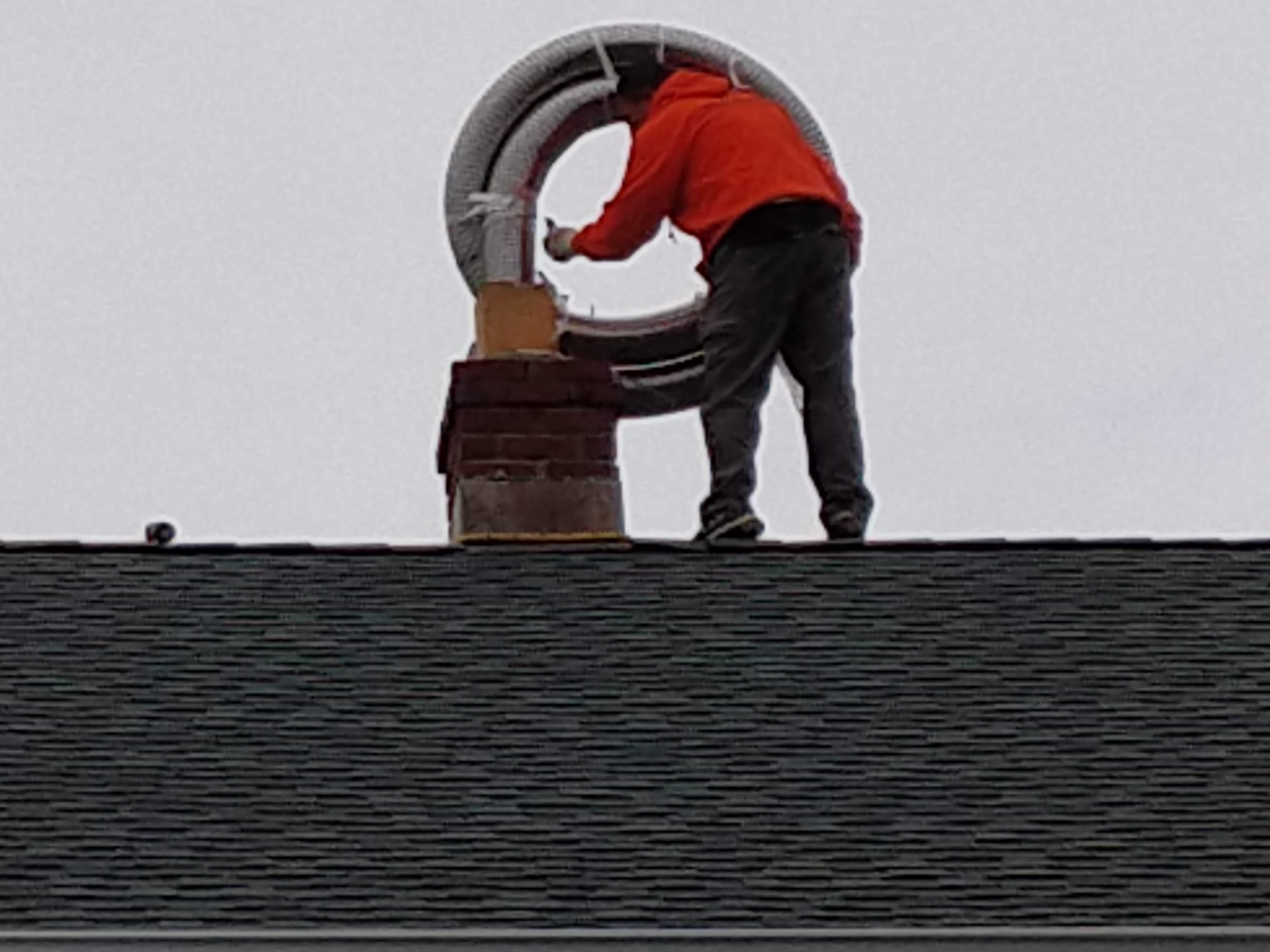 Flexible stainless chimney liner being installed in West Hempstead, New York